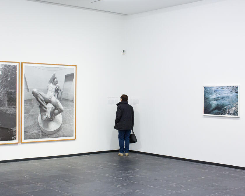 Galerij S.M.A.K. Gent met schilderijen en toerist die schilderijen staat te bewonderen.