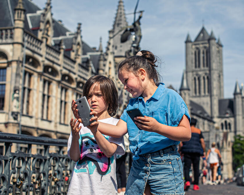 Two children with smartphone on St Michael's Bridge 