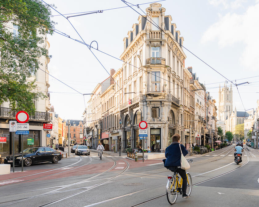 People on a bicycle and moped in the city centre