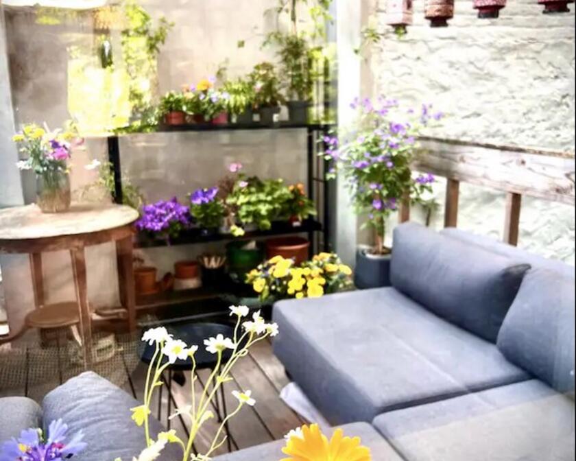 cosy terrace with grey corner seat and all kinds of plants