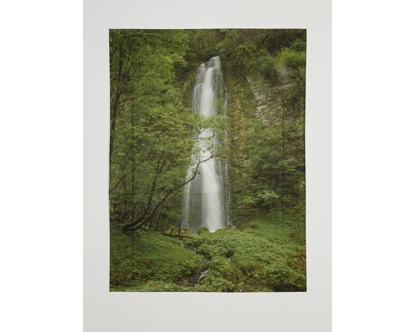 A waterfall in a green landscape