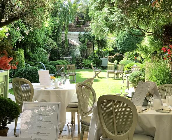 Terrace with set tables overlooking the garden