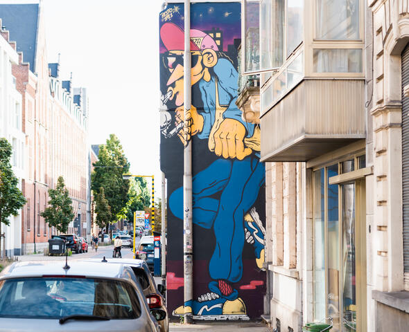 Mural of smoking man with cap, created by Resto.