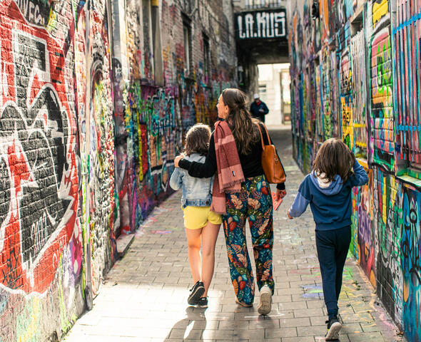 Family on a walk in the graffiti alley