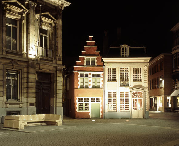 Monumental illuminated building with red facade on Kalandeberg
