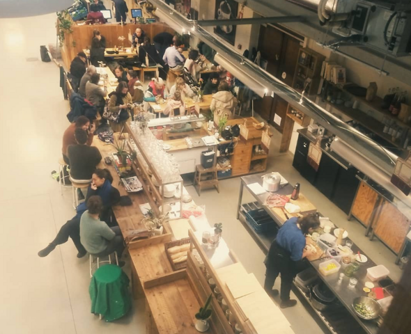 Top view of the busy open kitchen and the tables around it