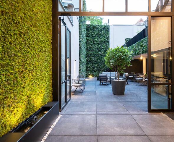 view of courtyard garden with terrace and vertical garden