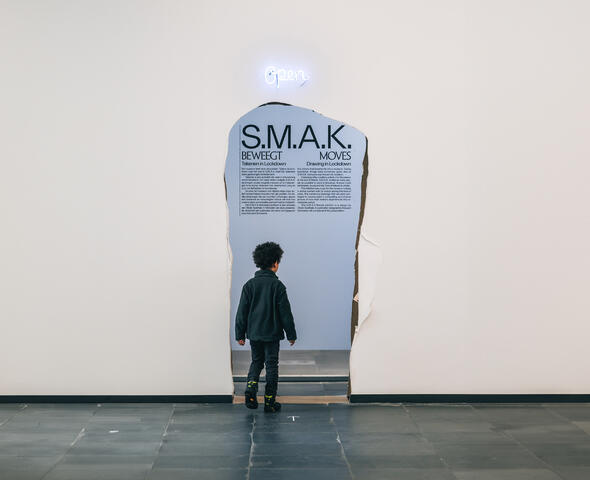 Een kindje loopt in een museumzaal