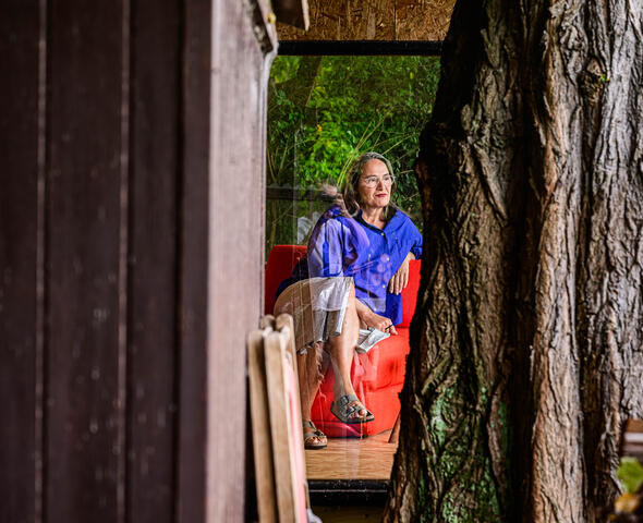Hilde Bouchez on a red armchair in her country residence
