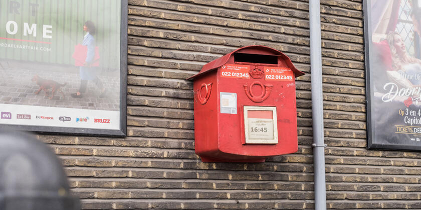 Wall with red mailbox.