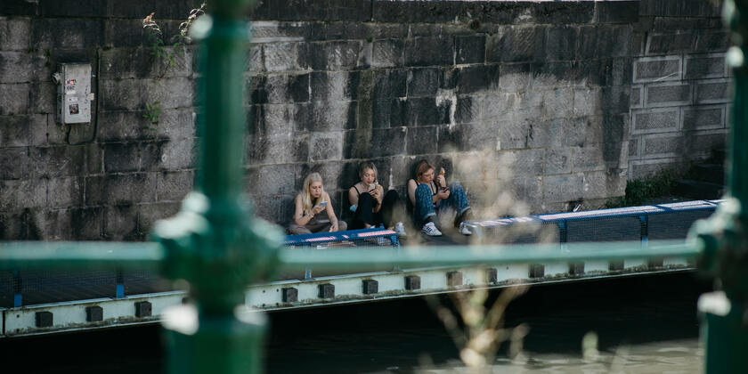 Meisjes met smartphone aan het water