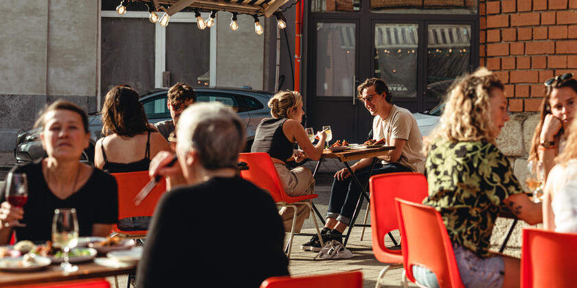 Guests dine on sunny terrace