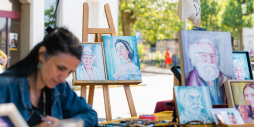 Woman paints portraits