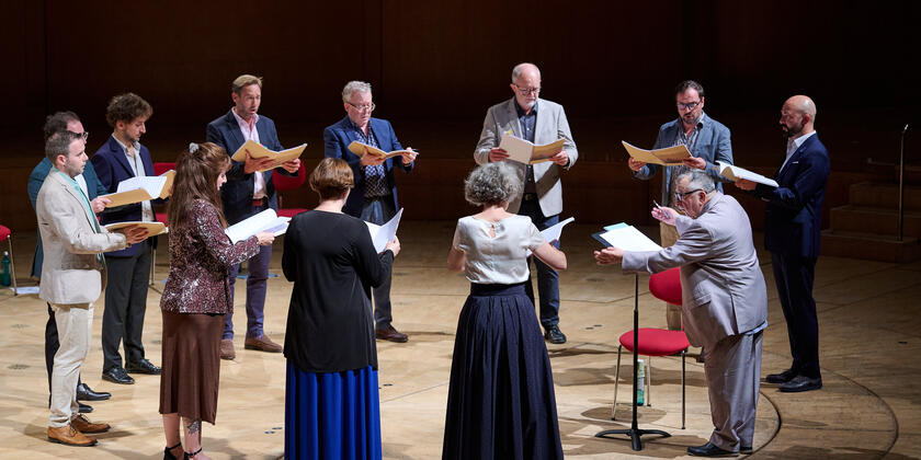 Mixed choir singing under the direction of a conductor