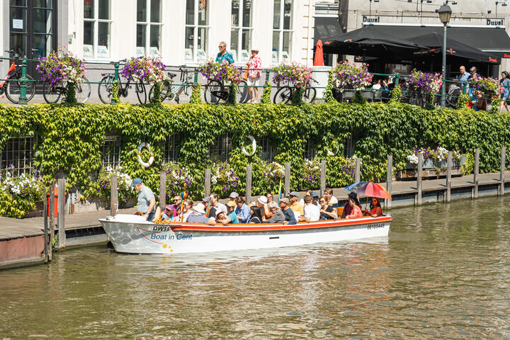 Boot met toeristen op het water langs de kade