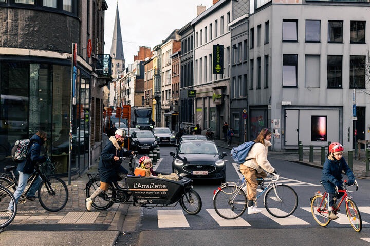 Several cyclists cross the street at Oude Beestenmarkt in Ghent