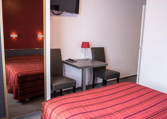 Zicht van een kamer met tweepersoonsbed in het hotel.