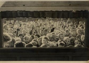 Audience of children watching a puppet theatre