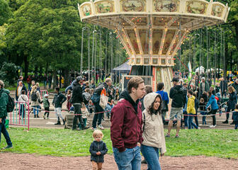 People on a walk along a merry-go-round
