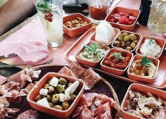 Plates with cold cuts, cheese and olives