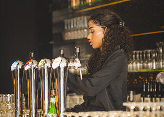 Bar Godot, waitress tapping beer 