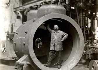 Schwarz-Weiß-Foto eines Mannes in einer Fabrikhalle