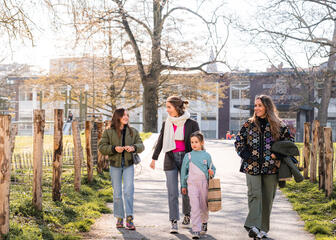 Tiany Kiriloff strolls through Baudelo Park with her three daughters on a sunny day