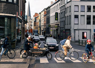 Several cyclists cross the street at Oude Beestenmarkt in Ghent