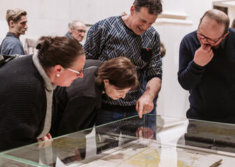 Les visiteurs d'un musée admirent des objets dans une vitrine