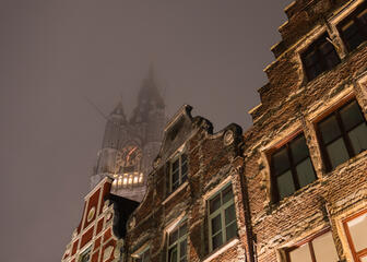 Beautiful view of the illuminated tower of the Belfry from the Mageleinestraat in Ghent