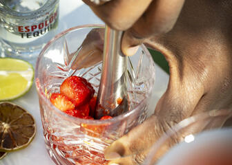 close-up of a glass in which strawberries are crushed