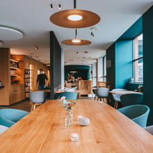 Scandinavian interior with wooden tables and light blue seats