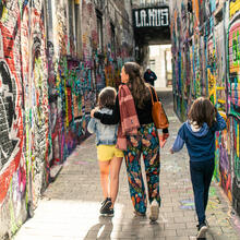 Family on a walk in the graffiti alley