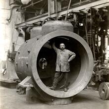 Black and white photo of man in a factory building