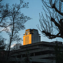 The last rays of sunshine shine on the grey Book Tower