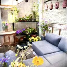 cosy terrace with grey corner seat and all kinds of plants