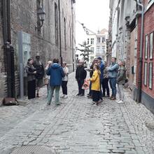Group of people stand in the middle of a traffic-free street