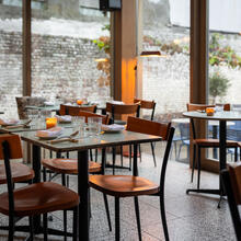 Tables set in restaurant Alberte with a view of the inner courtyard.